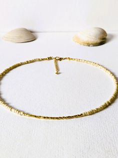 Pretty necklace with beige slightly shimmering rocailles beads (3 mm) and gold plated miyuki beads (2 mm). The necklace is 41,5 cm long and can be extended to 44, 5 cm The clasp as well as the extension chain are gold plated. The 14 carat gold filling is about 100 times thicker than simple gold plating. The gold layer is mechanically bonded to the basic brass material. The necklace is wonderful to wear together with other fine necklaces from my store. Other beautiful jewelry can be found here: https://www.etsy.com/de/shop/MerlesSchmuckArt Small inclusions, color variations and irregularities in the beads or even the metals are part of the peculiarity of the materials. Your purchased item will be sent to your home wrapped in tissue paper and a wine red organza bag. If you have any special r Dainty Gold Heishi Beads Jewelry, Gold Heishi Beads For Gift, Beige Beaded Necklace With Gold Round Beads, Minimalist Gold Beaded Necklace With Colorful Beads, Minimalist Gold Beaded Chain, Gold Heishi Beaded Chain Jewelry, Minimalist Gold Beaded Necklaces With Tiny Beads, Gold Jewelry With Heishi Beads And Beaded Chain, Gold Heishi Beaded Necklaces