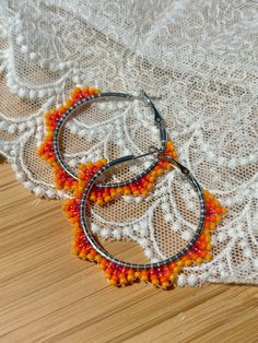 Hand beaded hoop earrings.  Hinge closure. Hoop measures approximately 1.5" wide. Adjustable Orange Hoop Earrings, Nickel-free Adjustable Hoop Beaded Earrings, Orange Beaded Hoop Earrings As A Gift, Nickel-free Small Hoop Beaded Earrings For Summer, Orange Beaded Hoop Earrings For Gift, Orange Small Hoop Earrings With Ear Wire, Adjustable Small Beaded Hoop Earrings, Nickel-free Orange Hoop Earrings, Orange Beaded Hoop Earrings