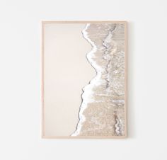 an abstract painting with white and silver paint on the wall next to a wooden frame