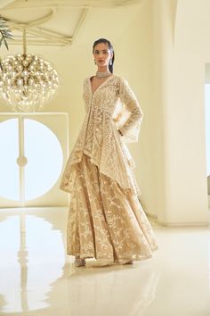 This high-low jacket sharara set features ivory thread, sequin, and pearl embroidery. The full-sleeved top shows pearl detail along the neckline, wrist, and at the hem of the Sharara top. It is paired with a fully embroidered dupatta.From Seema Gujral's Fiori - the sharara edit collection. DELIVERY TIME Please allow 8-12 weeks for your outfit to arrive. FABRIC DETAILSNet Professional cleaning only. Sharara Top, Jacket Sharara, High Low Kurti, Dotti Dresses, Eid Clothes, Seema Gujral, Desi Vibes, Sharara Designs, Nikah Dress