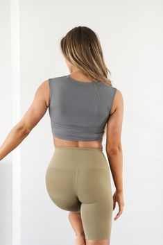 Embrace the sweat in this supportive Eva Essential Cropped Top. Sleek, soft and comfortable meets function in this workout top. Be confident during your next sweat sesh knowing you're covered. This sleeveless top has a cropped hem and high neck. Model is 5’5” wearing a size small Total Length of a small is 13.5" 72% Nylon, 28% Lycra High Stretch Sleeveless Versatile Sports Bra, Versatile High Stretch Sports Bra, Versatile High Stretch Sleeveless Sports Bra, Versatile Tank Activewear, Versatile Compressive Sleeveless Activewear, Versatile High Stretch Sleeveless Activewear, Gray Go-dry Athleisure Top, Functional Tank Activewear For Pilates, Versatile Compressive Tank Top For Gym