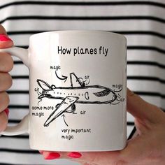 a woman holding a coffee mug with an airplane diagram on it