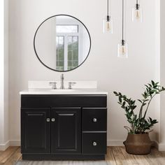 a bathroom with a sink, mirror and potted plant on the floor in front of it