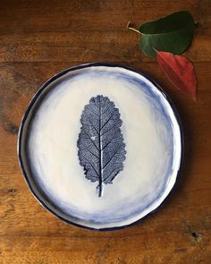 a plate that has a leaf on it