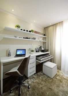 a room with a desk, chair and computer on top of the desk in front of a window