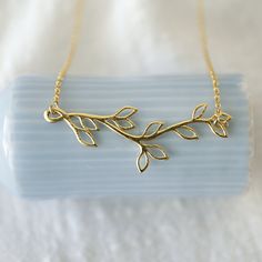 "Beautiful and lovely gold branch necklace made of gold plated branch with leaves pendent with skinny gold plated brass chain. Soft and natural. Great for everyday, special occasions or gift item. Your item will ship in a gift box. Please feel free to contact me if you have any questions. ♥ Chain length 14\" -20\" ♥ Branch 5/8\" x 2\" ♥ Gold plated over brass ♥ See more Rudiana Accessories Rudiana.etsy.com" Gold Nature-inspired Necklaces For Mother's Day, Pretzel Necklace, Branch With Leaves, Forest Necklace, Leaves Necklace, Prom Necklaces, Gold Branches, Necklace Tree, Gold Moon Necklace