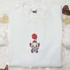 Baby Pennywise Embroidered Sweatshirt, Horror Movie Embroidered Hoodie, Halloween Embroidered Shirt Tinicloset is the embodiment of bespoke fashion, an enclave where self-expression is stitched into every garment. Within our boutique, an exquisite collection of custom embroidered apparel awaits, curated with meticulous attention to detail. From shirts to sweatshirts, T-shirts to hoodies, each piece is a... White Long Sleeve Hoodie With Embroidered Graphics, Cute Embroidered Hoodie For Streetwear, Halloween White Sweatshirt With Embroidered Graphics, White Halloween Sweatshirt With Embroidered Graphics, Embroidered Red Hoodie For Streetwear, Halloween White Embroidered Sweatshirt, White Hoodie With Custom Embroidery, White Hooded Top With Embroidered Graphics, Red Embroidered Hoodie For Streetwear