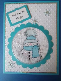 a christmas card with a snowman wearing a blue hat and scarf