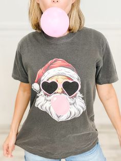 Fabric content: Graphic Tee: 100% Cotton Pink Graphic Print T-shirt For Winter, Holiday Winter Graphic Tee, Pink Graphic Tee With Cartoon Print, Pink Graphic Tee With Character Print, Winter Pink Graphic Print T-shirt, Santa Graphic, Graphic Tee, Graphic Tees, Sweatshirts