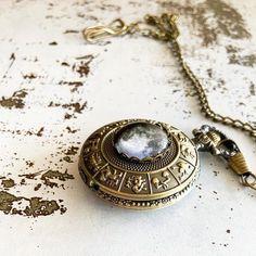 A beautiful antique bronze or silver tone pocket watch necklace featuring a very special Moon phase - yours! You provide a date for us, we look up what the phase of the Moon was that night, and we create this timeless (haha, pun intended) keepsake that makes a wonderful gift. There is also space inside for you to place a photo should you choose. The pocket watch runs on a regular watch battery that is changeable, pops open with the easy click of a button on the top and is easily set by turning t Vintage Pocket Watch Gift, Vintage Pocket Watch With Metal Dial Gift, Antique Gold Quartz Pocket Watch As Gift, Steampunk Pocket Watch With Compass Design, Steampunk Bronze Pocket Watch Gift, Gold Engraved Steampunk Pocket Watch, Steampunk Engraved Pocket Watch As Gift, Antique Pocket Watch As Gift, Vintage Antique Gold Pocket Watch As Gift