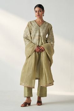 Sage green full flared sleeves kurta with gul dori-sequin embroidery and ghungroo embellishments on the sides. Paired with a pant and a striped dupatta with gold fringed borders. - Aza Fashions Pista Green Palazzo Set With Mirror Work, Pista Green Georgette Kurta With Mirror Work, Pista Green Chinon Kurta With Mirror Work, Long Sleeve Chinon Sharara With Mirror Work, Elegant Pista Green Palazzo Set With Mirror Work, Festive Embroidered Long Sleeve Palazzo Set, Pista Green Straight Kurta With Mirror Work, Chinon Anarkali Set With Chikankari Embroidery, Chikankari Embroidery Anarkali Set With Long Sleeves