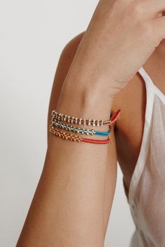 Woven single wrap bracelet with gold bead detail. Adds a playful layer of color to any bracelet stack. 18k gold plated sterling silver. 6" - 8" adjustable. Handmade in Vietnam.