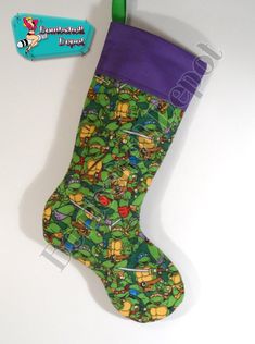 a stocking hanging from a green pole with teenage mutants on it