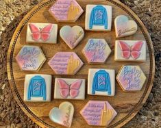 some cookies are arranged on a wooden plate