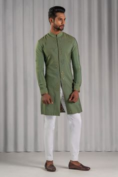 Green long bundi with all-over floral mirror embellishments and band collar. Comes with chikankari kurta and white pant.
Component: 3
Embroidered
Neckline: Band Collar
Sleeve Length: Kurta: Full; Bundi: Sleeveless
Fabric: Cotton Silk
Color: Green
Embroidered kurta
Concealed embroidered placket
Long bundi
Straight fit pant - Aza Fashions Fitted Kurta With Chikankari Embroidery And Stand Collar, Designer Bandhgala With Stand Collar For Festivals, Bandhgala With Chikankari Embroidery For Eid, Festive Stand Collar Kurta With Intricate Embroidery, Eid Bandhgala With Chikankari Embroidery And Stand Collar, Fitted Long Sleeve Chanderi Bandhgala, Fitted Kurta With Zari Work And Stand Collar, Embroidered Kurta With Stand Collar For Festivals, Chanderi Bandhgala With Mirror Work And Long Sleeves