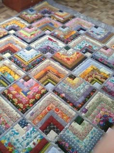 a large quilt is laying on the floor