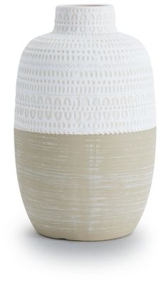 a white and beige vase sitting on top of a table