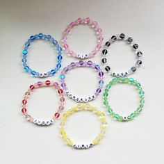 six bracelets with name beads on them