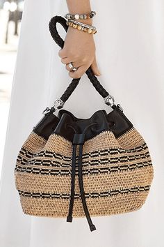 This fresh and flirty natural raffia straw bag is hand-crocheted with a detailed chain-link motif woven into the body. Deceptively roomy, it goes with everything. The multi-strand Italian handcrafted pebbled leather strap and black leather crossbody strap give it great versatility. Multi Strand, Crossbody Strap, Hand Crochet, Pebbled Leather, Leather Crossbody, Chain Link, Straw Bag, All Black, Leather Straps