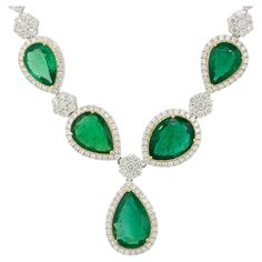 18 Karat White and Yellow Gold 19.39 Carat Pear Shaped Emerald and Diamond Drop Necklace Material: 18 Karat White Gold, 18 Karat Yellow Gold Gemstone Details: There are approximately 19.39 carats of Pear shaped Emeralds. There are 5 Emeralds total throughout this necklace Diamond Details: There are approximately 4.61 carats of Round Brilliant Cut Diamonds. There are 270 Diamonds total in this necklace Total Weight: 33.98g (24.2dwt) Additional Details: This item comes with a presentation box! SKU Diamond Drop Necklace, Green Tone, Necklace Diamond, Unique Necklace, Diamond Drops, Beautiful Necklace, Fine Jewellery Necklace, Drop Necklace, Unique Necklaces