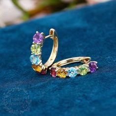 "❤Jewelry Details -Gold Type:  Solid 10K Gold / Solid 14K Gold / Solid 18K Gold (Choose One in Material Option) Stone Type: Natural Colored Gemstone (Red Tourmaline, Citrine, Blue Topaz, Peridot, Amethyst) Total Carat Weight: Approximately 3.0ct , 4.0mm*10pcs Color: 3A Clarity: VS Cut: Round Cut / 3EX Earrings Form Factor Size: 17*16mm SKU: YE0060 ❤The link for the same style ring is https://www.etsy.com/listing/1274158309/natural-colored-gemstone-ring-women?click_key=11c07786afd07133520572023a3bbb8601a786c9%3A1274158309&click_sum=69310cc3&ref=shop_home_active_20&pro=1&frs=1&sts=1 ❤The link for the same style pendant is https://www.etsy.com/listing/1260149690/round-cut-natural-colored-gemstone?click_key=17446ef01b4277e7f3d0363bad383bd417151a40%3A1260149690&click_sum=998eccd6&ref=shop_home_ Formal Yellow Gold Hoop Earrings With Gemstones, Formal Yellow Gold Gemstone Hoop Earrings, Yellow Gold Multi-stone Earrings In Cubic Zirconia, Formal Round Gemstone Hoop Earrings, Elegant Multi-stone Hoop Earrings, Yellow Gold Cubic Zirconia Multi-stone Earrings, Yellow Gold Multi-stone Earrings For Anniversary, Formal Cubic Zirconia Gemstone Hoop Earrings, Elegant Multicolor Gemstone Hoop Earrings