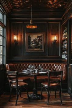 an empty restaurant with leather booths and wooden tables in front of large windows, lit by lamps