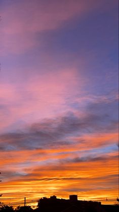 an orange and blue sky with some clouds