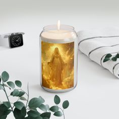 a candle that is sitting next to some towels