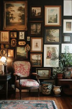 a living room filled with lots of framed pictures and paintings on the wall next to a chair