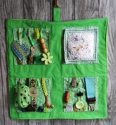 a close up of a bag on a wooden surface with buttons and other things in it