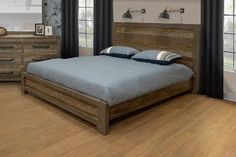 a large bed sitting in a bedroom on top of a hard wood floored floor