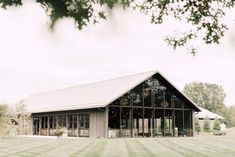 a large building sitting on top of a lush green field