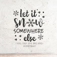 the words let it snow somewhere else are drawn in black ink on a white wall