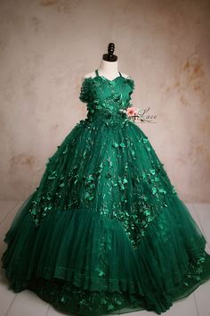 Elegant green ball gown with floral embellishments and a tulle skirt. Elegant Tulle Ball Gown For Christmas, Elegant Christmas Tulle Ball Gown, Fitted Green Ball Gown For Dress-up, Elegant Christmas Ball Gown, Holiday Ball Gown For Dress-up, Elegant Green Pageant Dress For Dress-up, Elegant Green Ball Gown For Pageant, Christmas Fitted Gown For Dress-up, Fitted Sleeveless Christmas Ball Gown