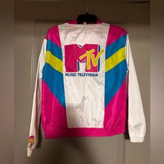 Never Worn Mtv Windbreaker, In Excellent Condition. No Holes Or Stains Size Small Retro White Outerwear With Letter Print, Sporty White Track Jacket With Letter Print, White Graphic Print Windbreaker For Streetwear, 90s White Sports Outerwear, White Letter Print Track Jacket For Streetwear, White Track Jacket With Letter Print For Streetwear, 90s White Windbreaker For Sports, White Casual Windbreaker With Graphic Print, Casual White Windbreaker With Graphic Print