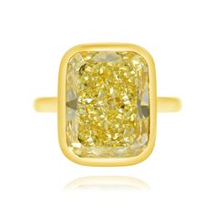 This magnificent ring features a valuable yellow diamond, which reminds us visually of a gold bullion bar. Luxury Yellow Diamond Ring, Luxury Gold Cushion Cut Rings, Gia Certified Rectangular Gold Diamond Ring, Luxury Radiant Cut Yellow Rings, Gia Certified Rectangular Yellow Gold Diamond Ring, Luxury Yellow Gemstone Rings, Gia Certified Cushion Cut Gold Jewelry, Formal Yellow Cushion Cut Diamond Ring, Gold Yellow Sapphire Rings With Diamond Cut