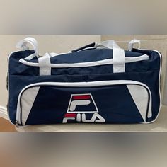 Vintage Fila Duffel Bag In Brand New Condition, Has Never Been Used. Navy Blue With Fila Logo On Front And Side. Dimensions: 23 Inches Long, 11 Inches Wide, 10 Inches High. Great Travel Or Gym Bag! Stored In A Pet Free, Smoke Free And Dirt Free Environment. Will Ship Next Day! #Vintagebag #Fila #Vintagefila #Travelbag Logo Travel, Fila Logo, Travel Logo, Blue Logo, Travel Tote, Vintage Bags, Duffel Bag, Blue Bags, 11 Inches