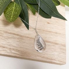 "Our hand pressed silver fern necklace offer a unique look and this tiny fern pendant is made from a real leaf. Perfect with any outfit, showcase your love for nature or plants with a Funky Art Designs Necklace This handmade fern print necklace is the perfect gift for your bridesmaids, mother-in-law, or any plant lover or gardener in your life. ITEM DETAILS - Necklace is Sterling Silver and measures 18\" long with lobster clasp closure. - Fern piece measures approximately  1\" x 1/2\" and are ma Sterling Silver Nature-inspired Necklace With Natural Inclusions, Minimalist Silver Necklace With Pressed Flowers, Nature-inspired Leaf Jewelry For Everyday, Teardrop Necklace With Natural Inclusions, Everyday Nature-inspired Leaf Jewelry, Silver Leaf-shaped Nature-inspired Necklace, Silver Teardrop Pendant Necklace Nature-inspired, Silver Nature-inspired Teardrop Pendant Necklace, Nature-inspired Leaf-shaped Jewelry With Pressed Flowers