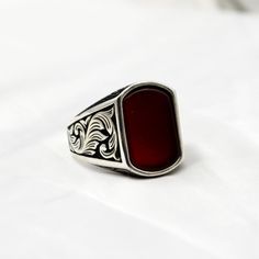 Introducing our striking sterling silver men's ring featuring a vibrant red agate stone. This bold and masculine design is perfect for adding a pop of color to any outfit. The deep red hue of the agate stone beautifully contrasts with the gleaming sterling silver setting, creating a timeless piece that is sure to turn heads. Treat yourself or a loved one to this unique and eye-catching accessory that effortlessly combines style and sophistication. Perfect for everyday wear or special occasions, Red Rings, Masculine Design, Sterling Silver Mens Rings, Minimalist Gifts, Mens Silver Rings, Ring For Men, Agate Ring, Red Agate, Accessories Fashion