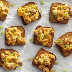 toasted bread topped with scrambled eggs and scallions