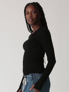 The Olivia long sleeve top is made from our stretchy rib knit and features our favorite undetected thumb holes. Pair with any sweatpants or style it up in your favorite denim. Fabric: 95% Rayon, 5% Spandex. Colorway: Onyx. Our model is 5'9" and wearing a size small. Machine Wash. Tumble dry low. Made in the USA. Ribbed Stretch Long Sleeve Top For Loungewear, High Stretch Casual Long Sleeve Top For Layering, Trendy Tops With Thumbholes For Loungewear, Trendy Long Sleeve Top With Thumbholes For Fall, Black Stretch Long Sleeve Top For Loungewear, Casual Stretch Long Sleeve Top With Thumbholes, Stretch Tops With Ribbed Cuffs For Everyday, Stretch Long Sleeve Top With Ribbed Cuffs For Layering, Stretch Long Sleeve Top With Thumbholes For Everyday