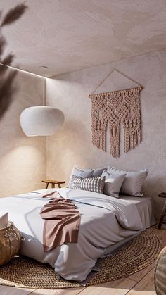 a bed sitting on top of a wooden floor next to a white lamp and chair