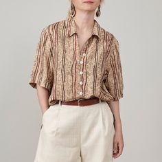 Introducing a chic vintage silk shirt for women who prefer earthy shades. This short sleeve pure silk blouse, best for women size XS to M, features a classic straight cut and relaxed fit, making it an ideal choice for breezy summer outfits in neutral tones. Its lovely beige and brown hues, accented with hints of burgundy, make it an elegant option for office wear when paired with dressy bottoms or a stylish choice for weekend ensembles with cozy shorts. This shirt is super lightweight, making it Elegant Half Sleeve Summer Shirt, Elegant Relaxed Fit Rayon Tops, Classic Relaxed Fit Rayon Blouse, Classic Collared Rayon Tops, Classic Blouse With Relaxed Fit, Elegant Beige Summer Shirt, Classic Rayon Blouse With Relaxed Fit, Classic Rayon Summer Shirt, Classic Short Sleeve Rayon Tops