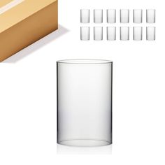 there are many glasses and boxes next to each other on the white surface, including one empty glass