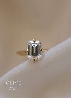 Archie | 14K Gold | Step Cut Moissanite Center Stone | #solitaire #engagementring #wedding Olive Avenue Jewelry, Emerald Cut Moissanite, Solitaire Setting, Forever One Moissanite, Step Cut, Engraved Items, Jewelry Companies, Stone Cuts, Perfect Ring