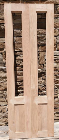 two wooden doors sitting next to each other on top of a stone wall and floor