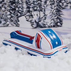 an inflatable boat floating on top of snow covered ground