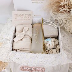 the baby gift box is filled with items for its new born girl, including blankets and diapers