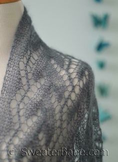 a woman's shawl is shown on a mannequin