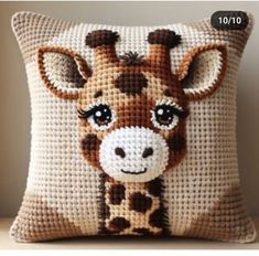 a close up of a pillow with a giraffe on it's face